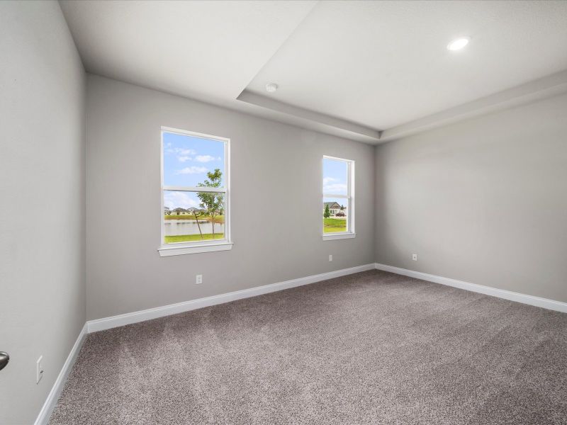 Primary Bedroom in the Coral floorplan at 6326 NW Sweetwood Drive in Brystol at Wylder