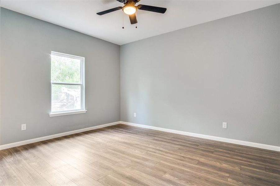 Empty room featuring wood-type flooring and ceiling fan