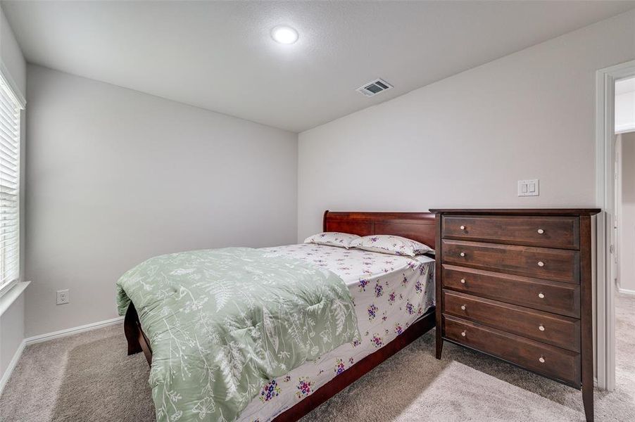 Bedroom featuring light colored carpet