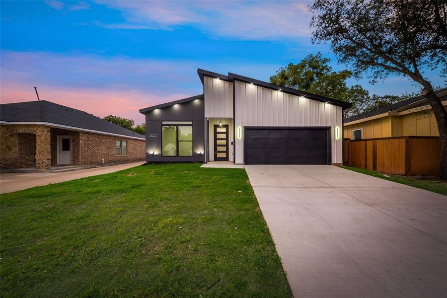 Modern home featuring a yard and a garage