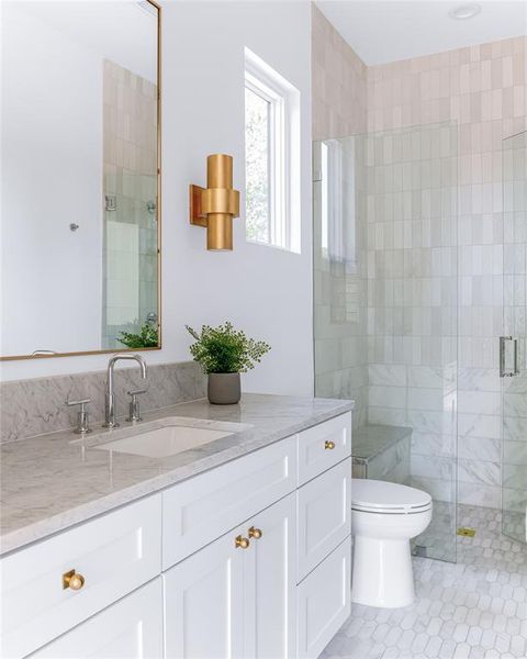 Bathroom with vanity, tile patterned flooring, toilet, and an enclosed shower