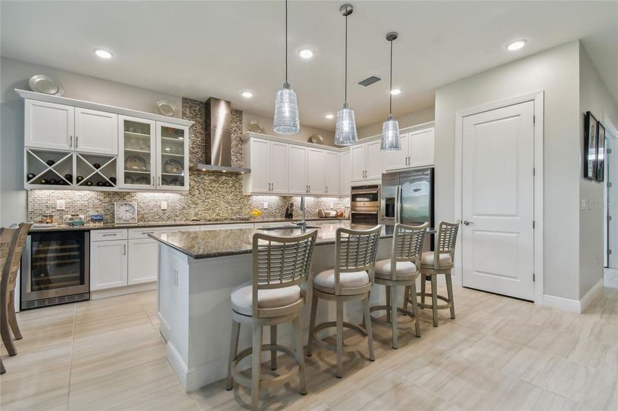 Gourmet kitchen with gas appliances and wine cooler fridge