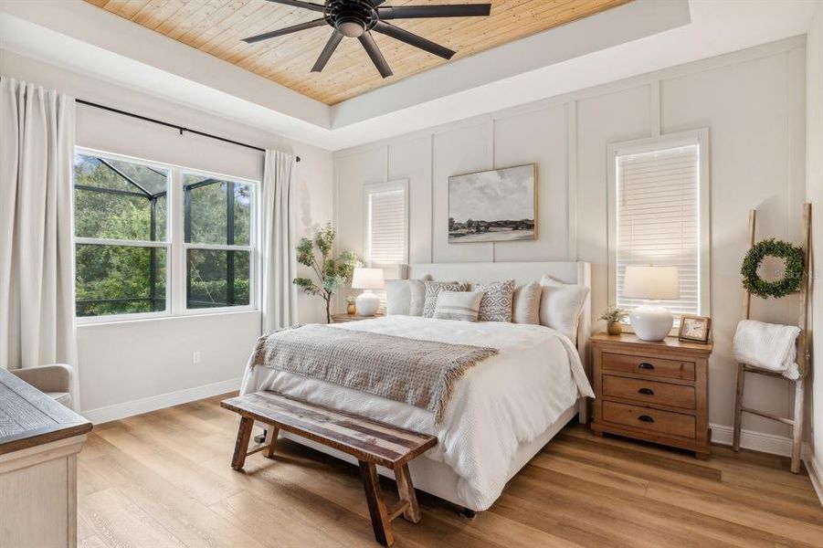 Primary Bedroom with wood inlayed ceiling and board & batten