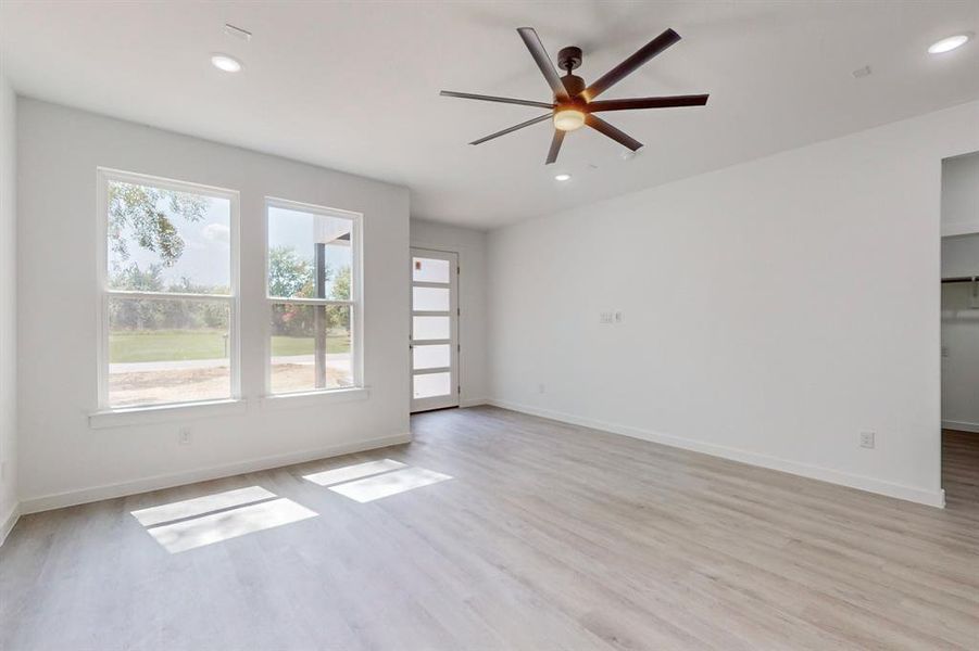 Unfurnished room with ceiling fan and light hardwood / wood-style floors