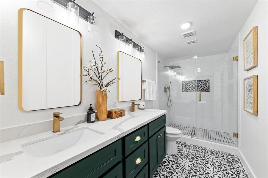 Primary bath includes double sinks, oversized glass frameless walk in shower and spacious walk in closet.