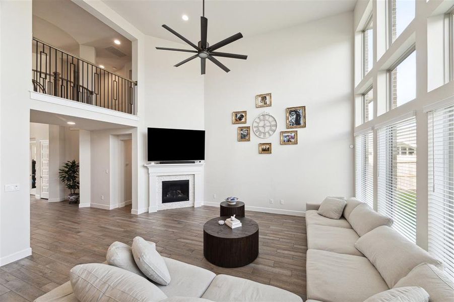 The family room includes a corner gas log fireplace with custom surround and mantle.