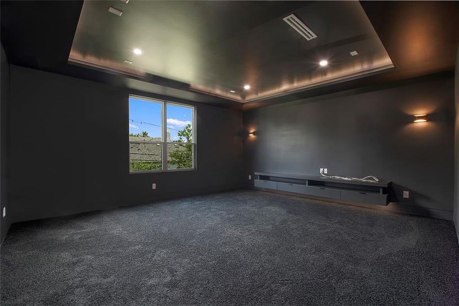 Carpeted empty room with a raised ceiling