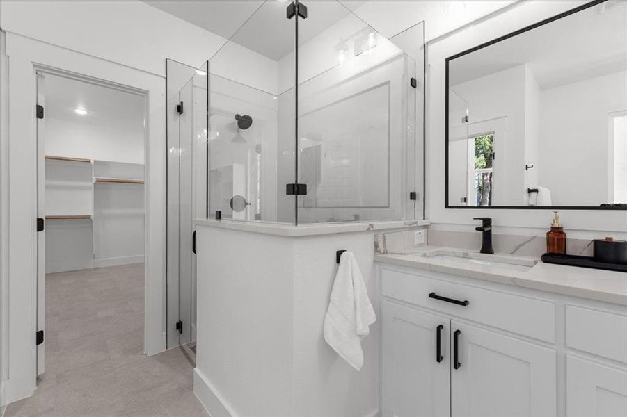 Bathroom with vanity and a shower with shower door