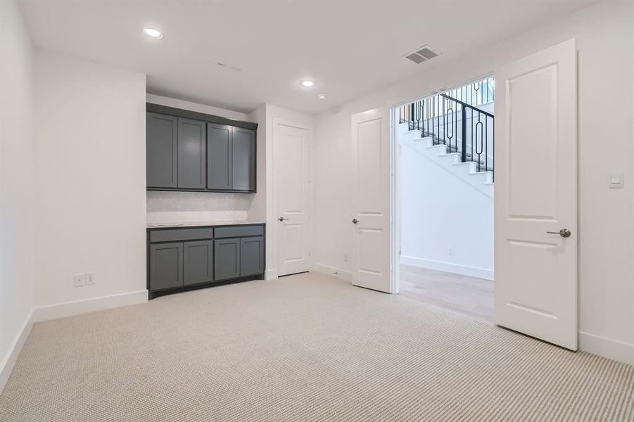 Basement featuring light carpet