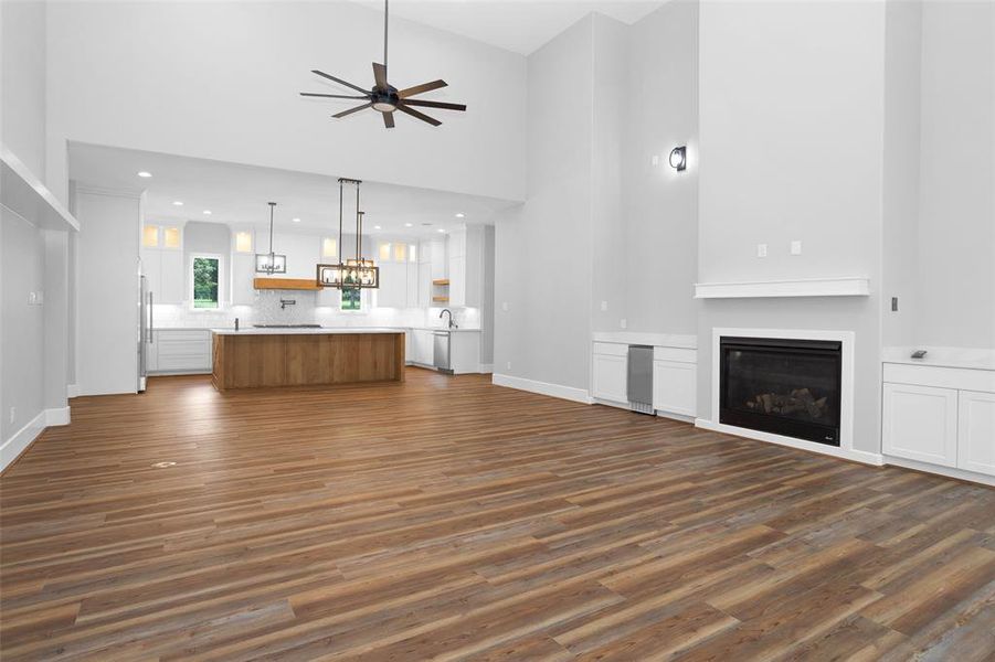 High ceilings, huge ceiling fan, and fireplace in the living room.