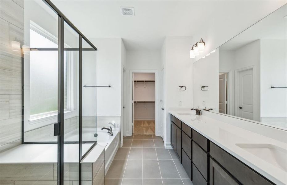 Elegant owner's bathroom with dual vanity *real home pictured