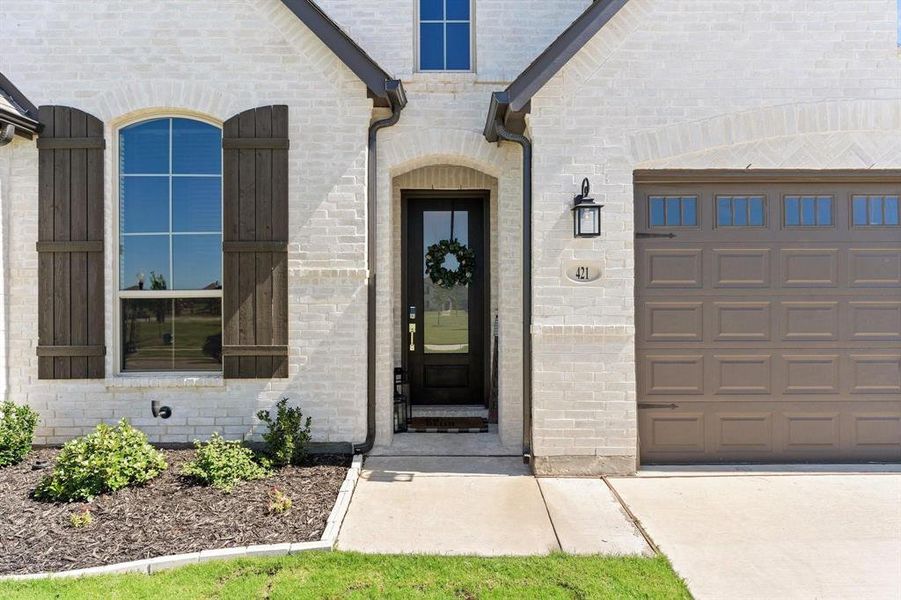 Doorway to property featuring a garage