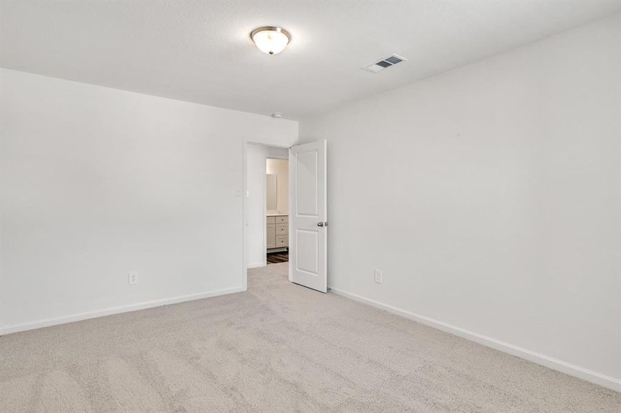 Spare room with light colored carpet