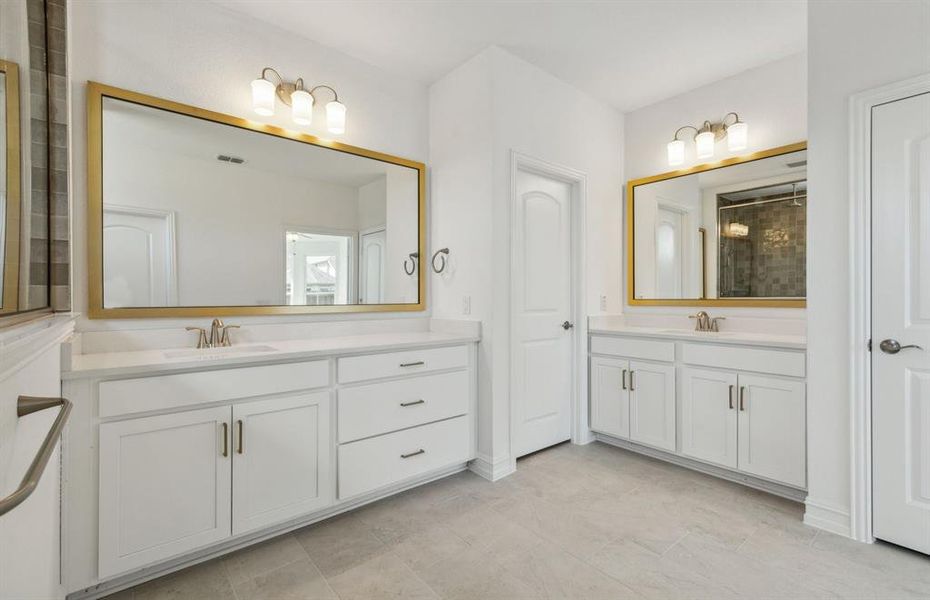 Spacious owner's bathroom with dual vanity *real home pictured