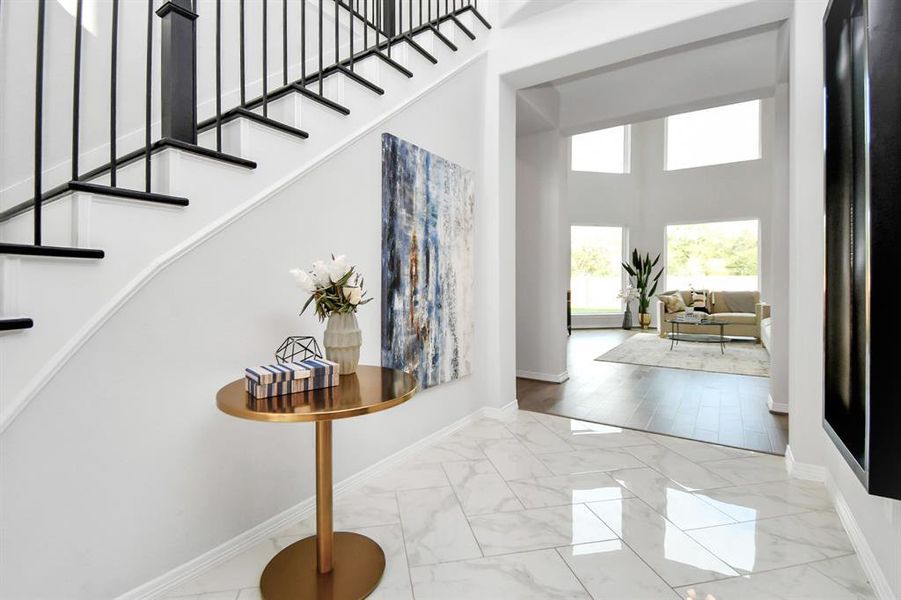 The elongated foyer boasts highceilings and is adorned with tastefuldecor, creating an immediate senseof elegance.