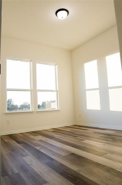 Unfurnished room featuring dark hardwood / wood-style flooring