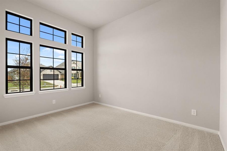 Your secondary bedroom features plush carpet, fresh paint, closet, and a large window that lets in plenty of natural lighting.