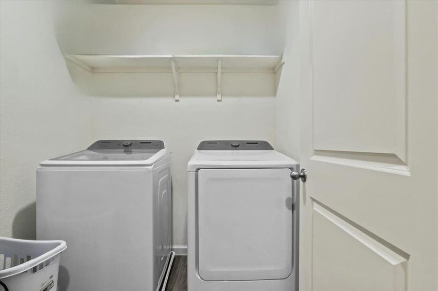 Laundry area featuring washer and dryer and hardwood / wood-style flooring