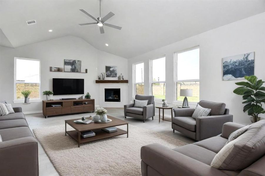 Relax and unwind in this inviting family room, illuminated by abundant natural light streaming in through tall windows, complemented by high ceilings and stunning flooring. Stay comfortable year-round with the gentle breeze from the ceiling fan, creating the perfect atmosphere for family gatherings. Sample photo, virtually staged.