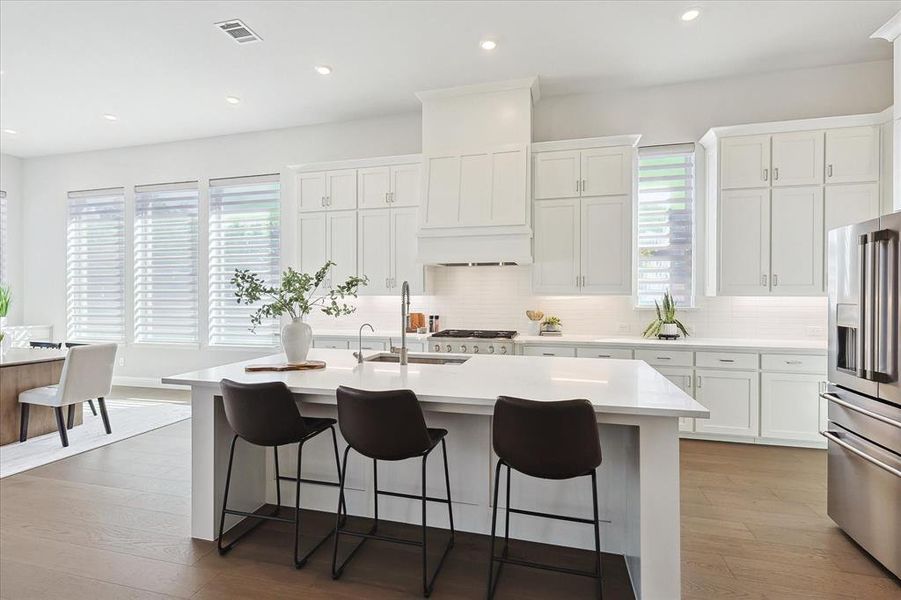 Kitchen featuring stainless steel appliances, a center island with sink, plenty of natural light, and sink