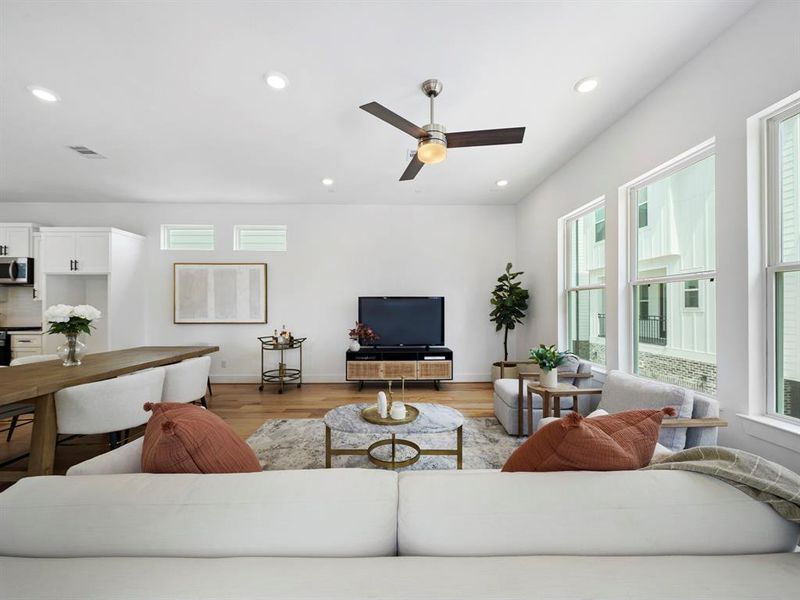 The living room's soaring high ceilings create an airy, spacious atmosphere, evoking a sense of grandeur and openness for an inviting and comfortable gathering space.