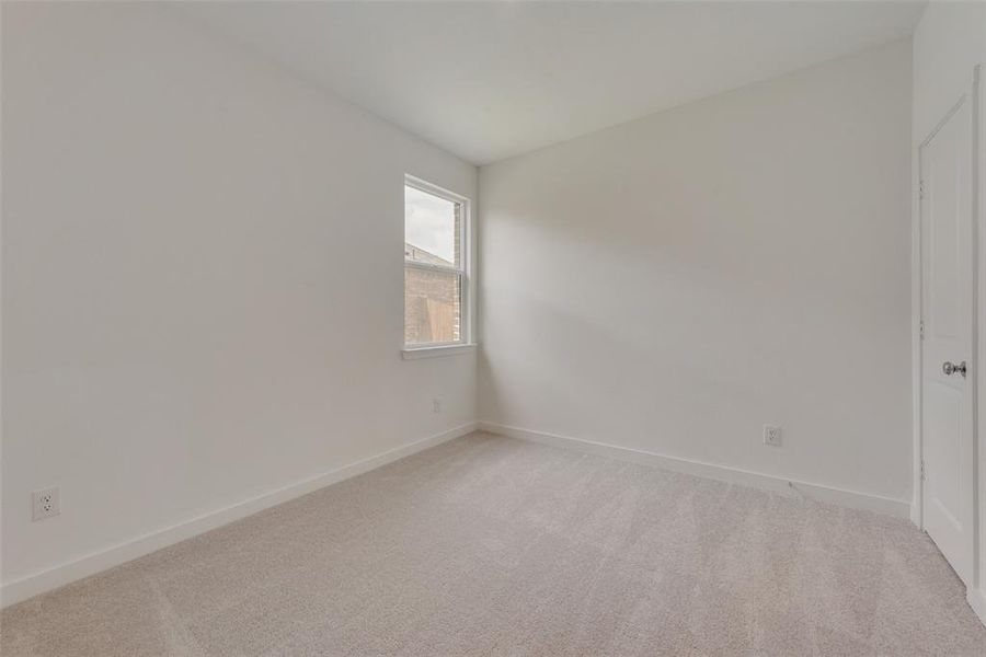 Unfurnished room with light colored carpet