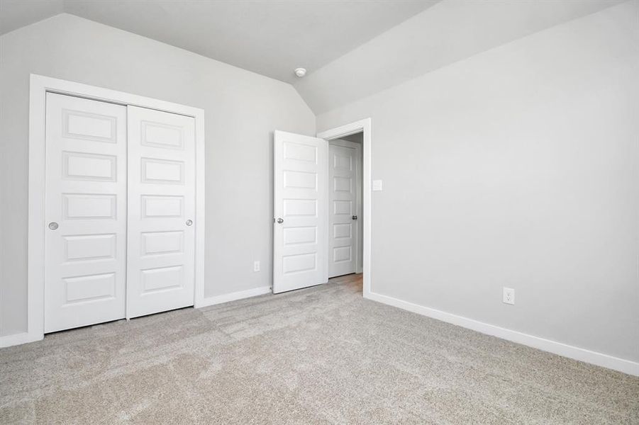 Generously sized secondary bedrooms featuring spacious closets, soft and inviting carpeting underfoot, large windows allowing plenty of natural light