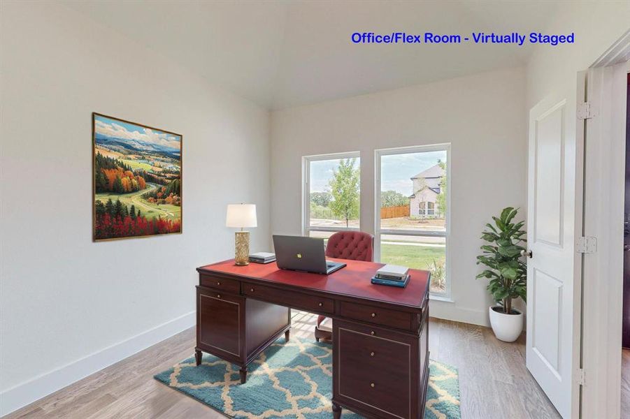 Office area with light hardwood / wood-style floors