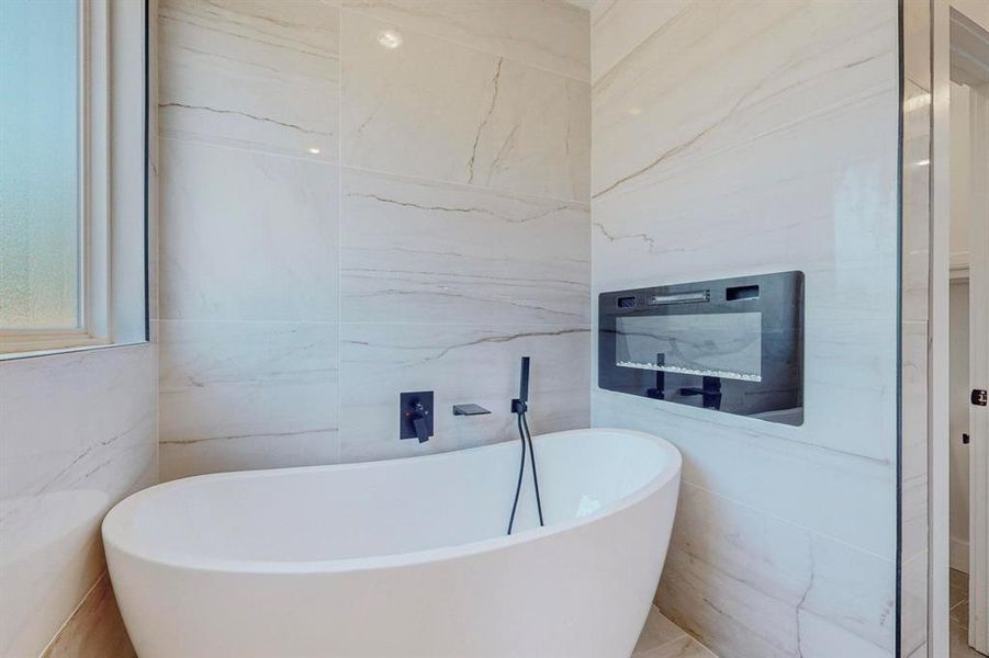 Bathroom with tile walls and a bathing tub