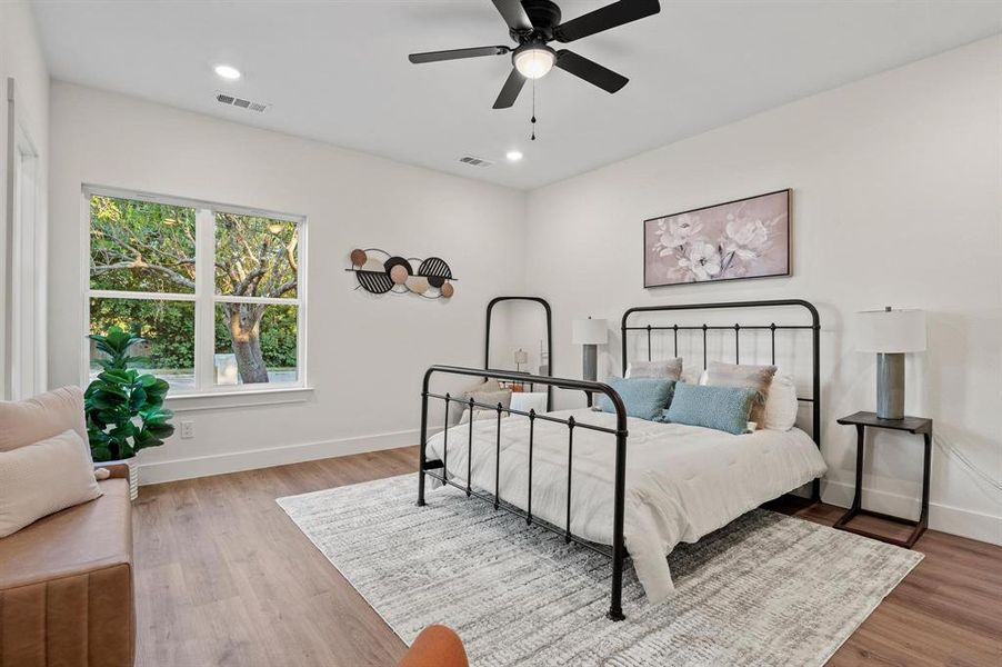 Bedroom with ceiling fan and light wood-type flooring