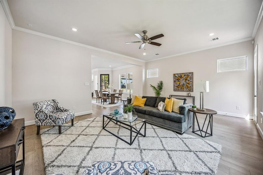 The refined atmosphere carries throughout the first floor with rich wood floors and crown molding accents, reflecting the home's fashionable vibe.