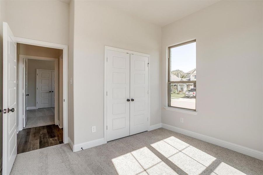 Unfurnished bedroom featuring a closet and hardwood / wood-style floors