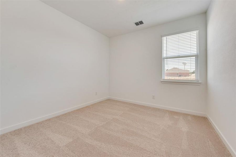 Spare room featuring light colored carpet