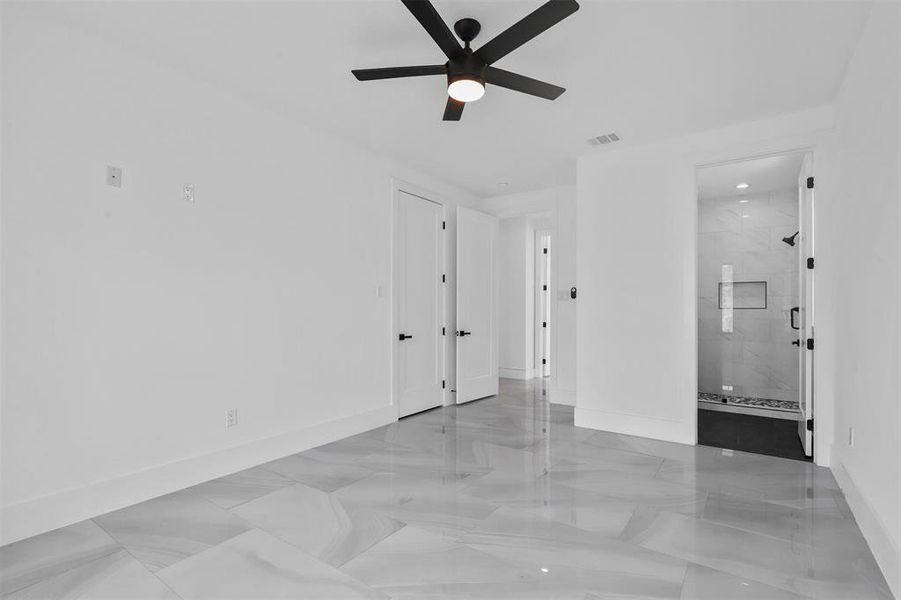 Guest suite with light tile patterned flooring and ceiling fan