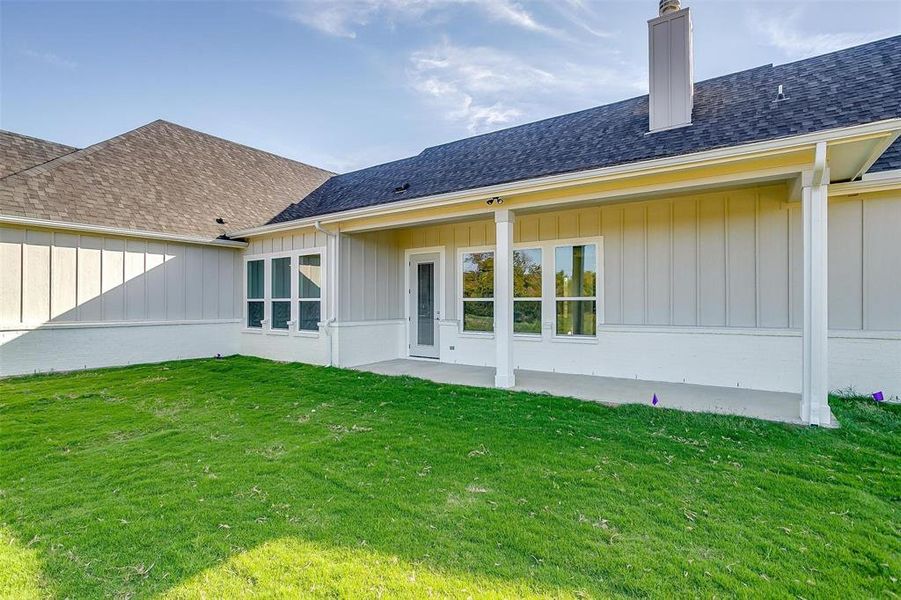 Back of house featuring a patio area and a yard