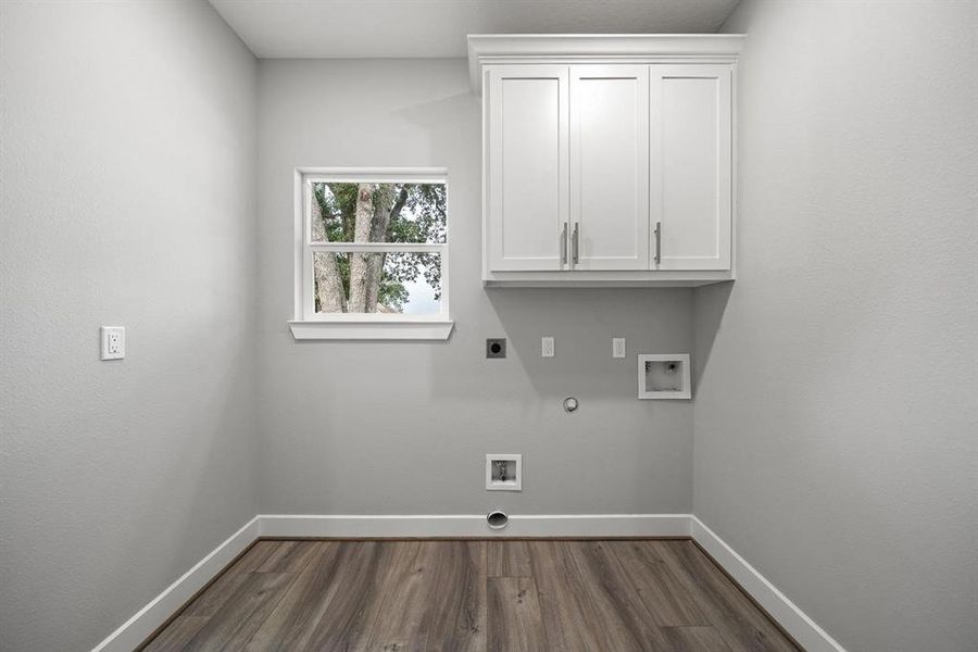 The 8.5 x 6 laundry room offers plenty of space for the washer and dryer. The custom built cabinet is great for keeping cleaning supplies out of sight.