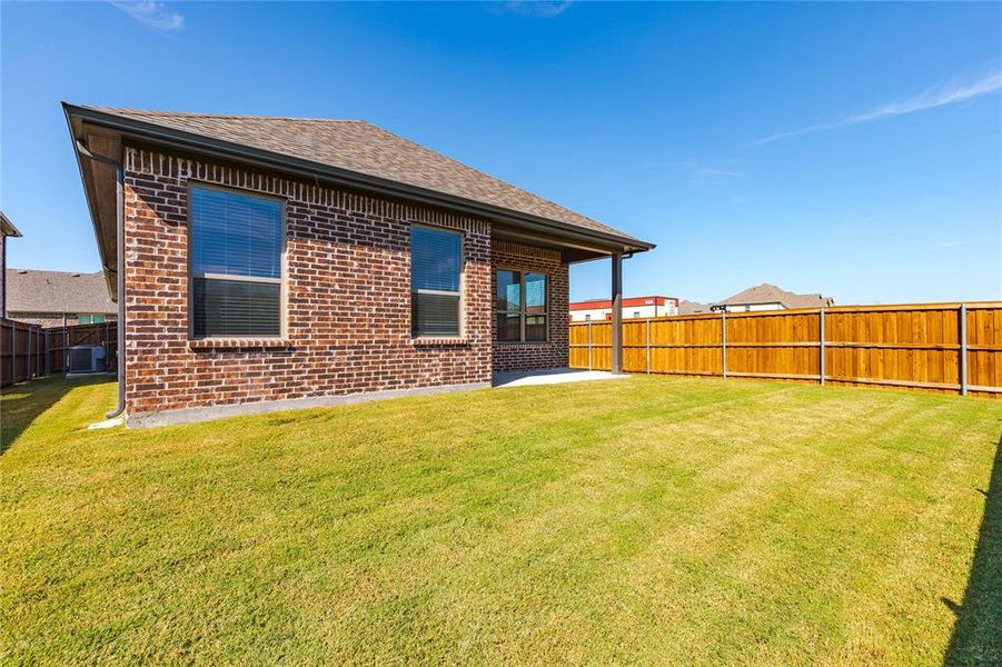 Back of house featuring a patio, cooling unit, and a lawn