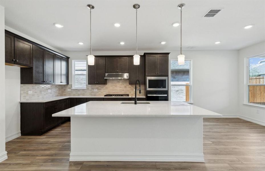 Spacious kitchen with oversized island *real home pictured