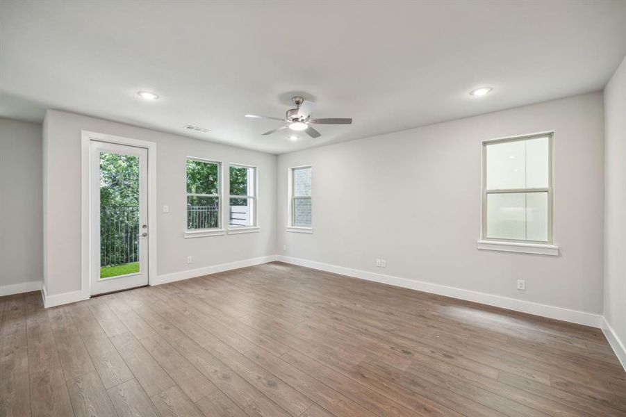 Spare room featuring wood-type flooring and ceiling fan