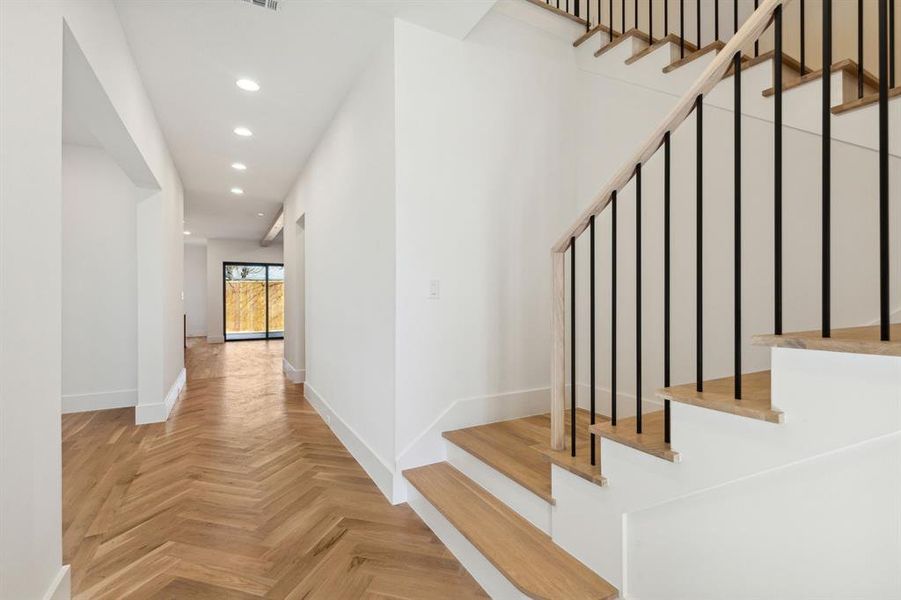 Staircase featuring wood floors