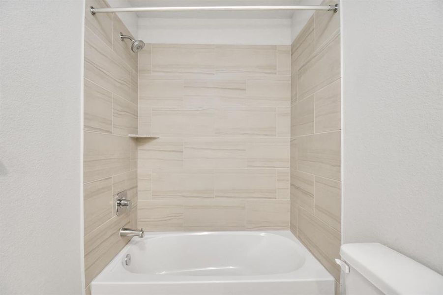 Another perspective of the walk-in shower with tile surround.