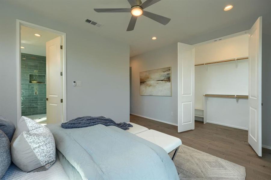 Primary bedroom with view of one of the two walk-in closets.