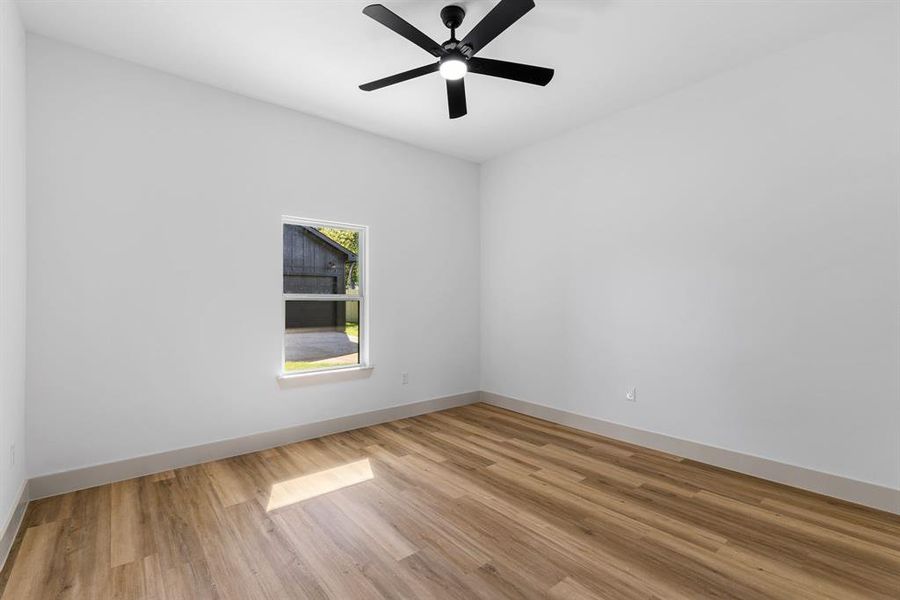 Spare room with ceiling fan and light hardwood / wood-style floors