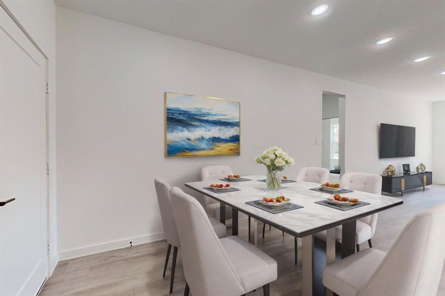 Staged Dining space featuring light hardwood / wood-style floors