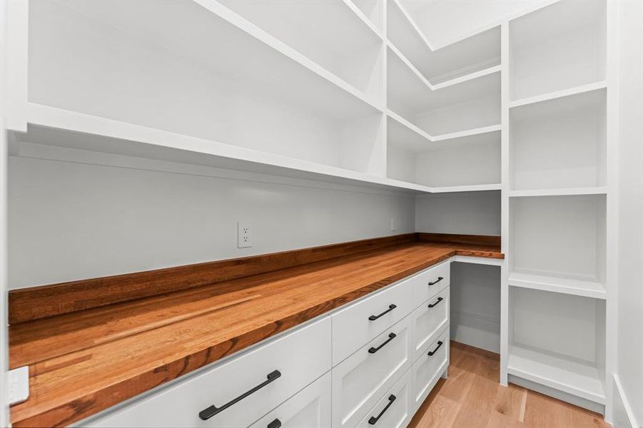 The expertly designed walk in pantry provides extensive storage, organization and function.