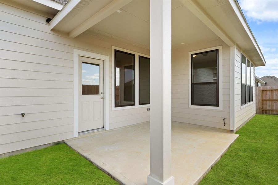 The covered patio is generously sized, providing ample space for various outdoor activities.