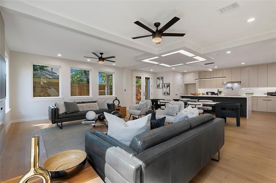 Living room with light hardwood / wood-style flooring and ceiling fan