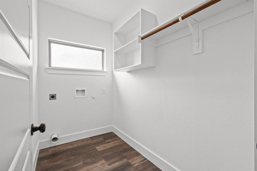 Clothes washing area with washer hookup, gas dryer hookup, hookup for an electric dryer, and dark hardwood / wood-style floors