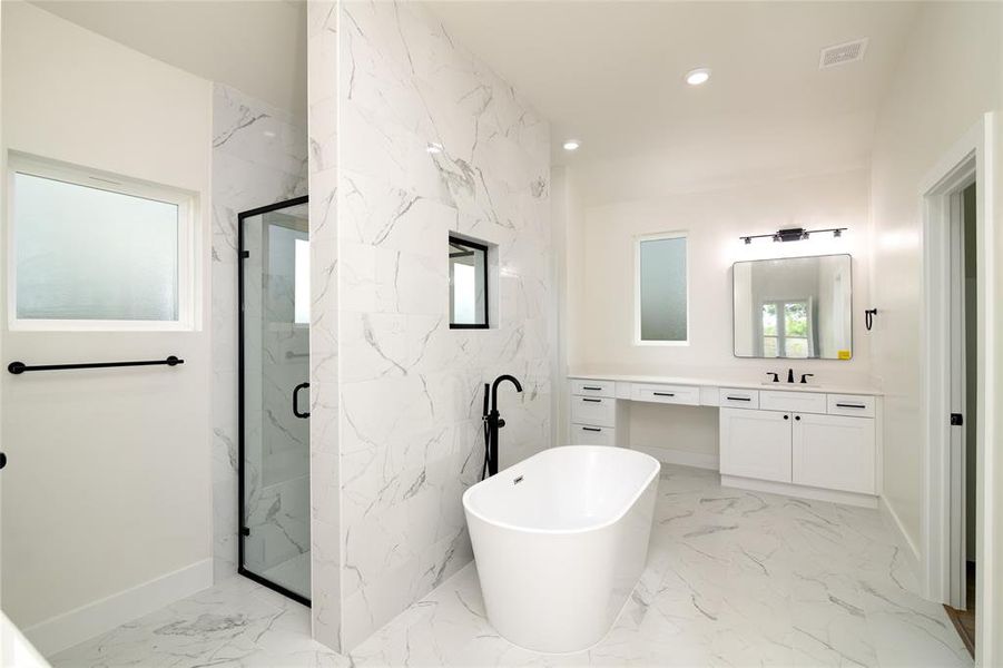 Master Bathroom featuring shower with separate bathtub and vanity