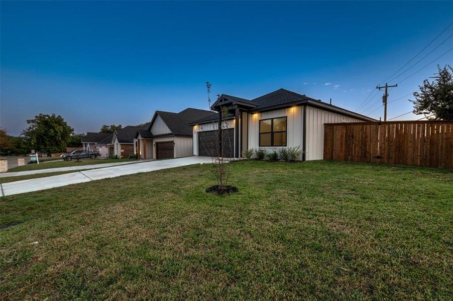 View of front of house featuring a front yard and a garage